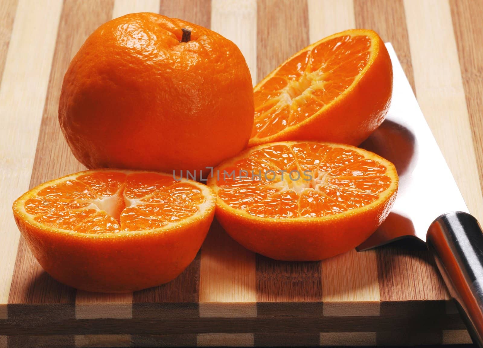 orange mandarin tangerine on wood cutting board