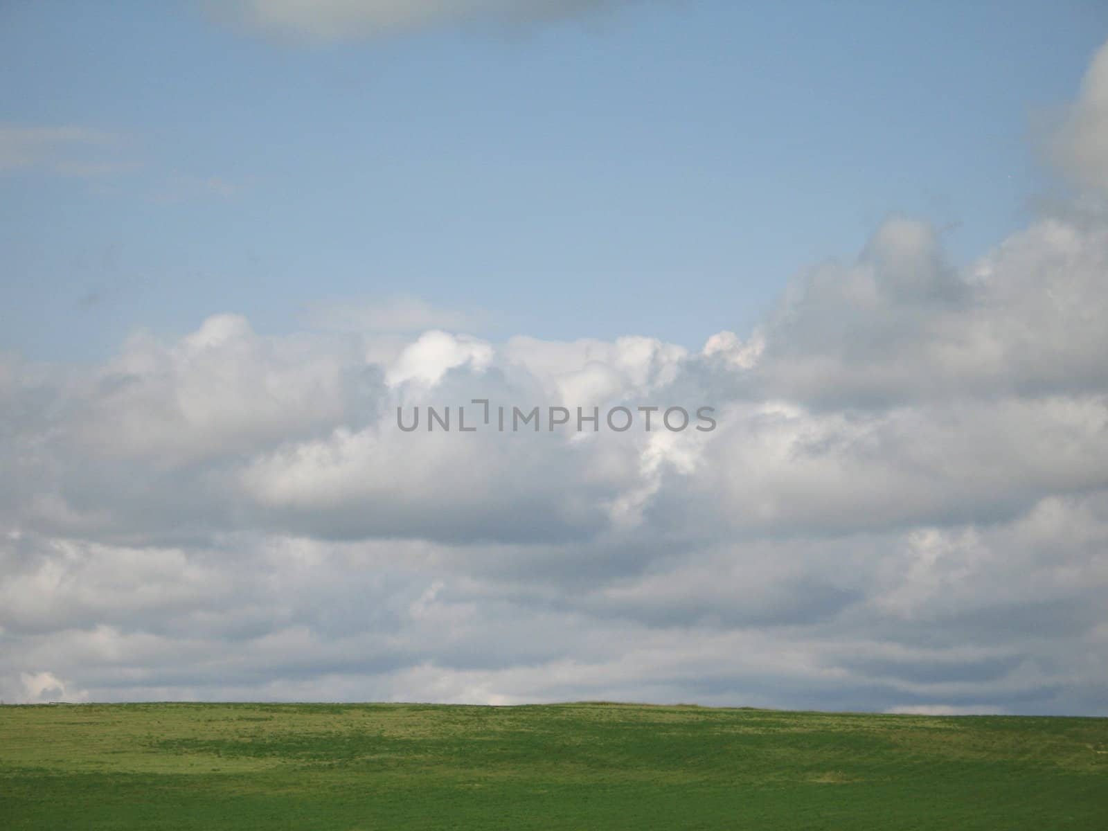 green valley and cloudy sky