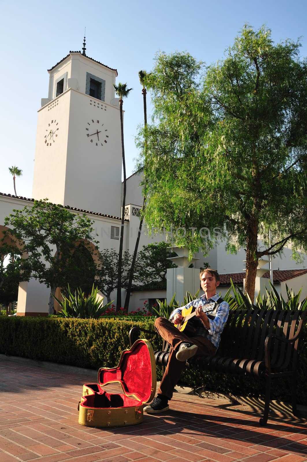 A street musician plays for money near the Union Station clock tower