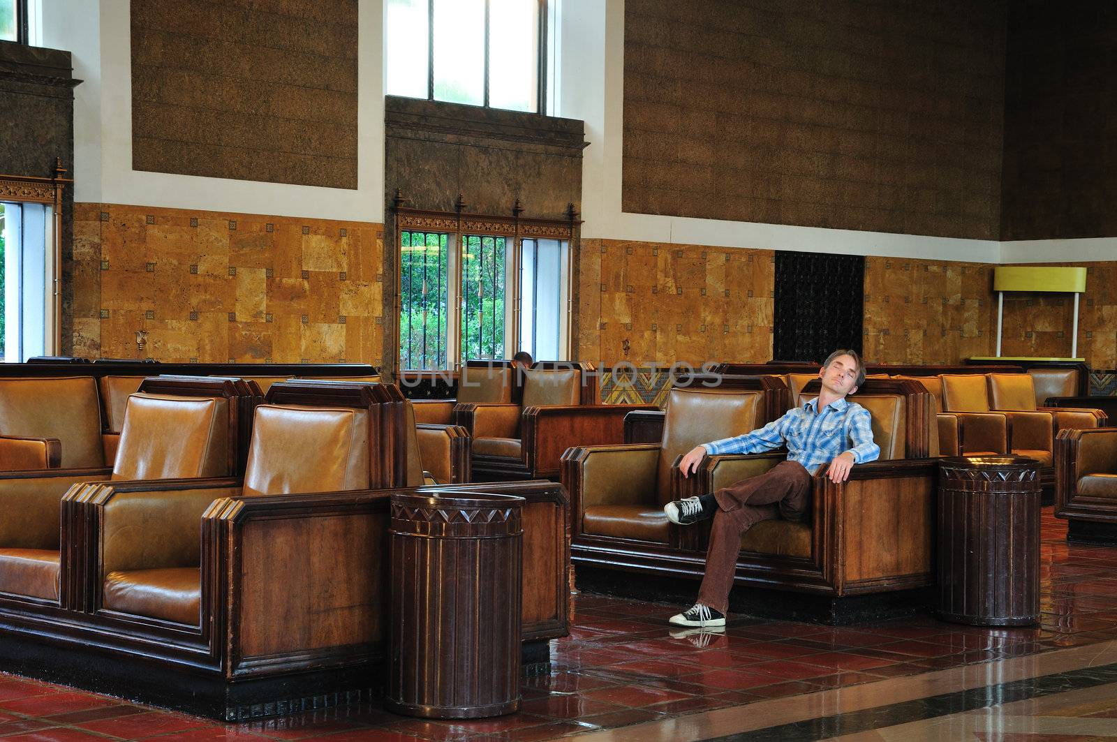 Passenger sleeps in the waiting room of Union Station in Los Angeles