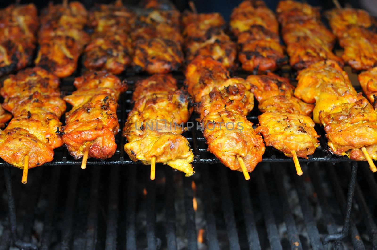 chicken cooking on an open flame grill