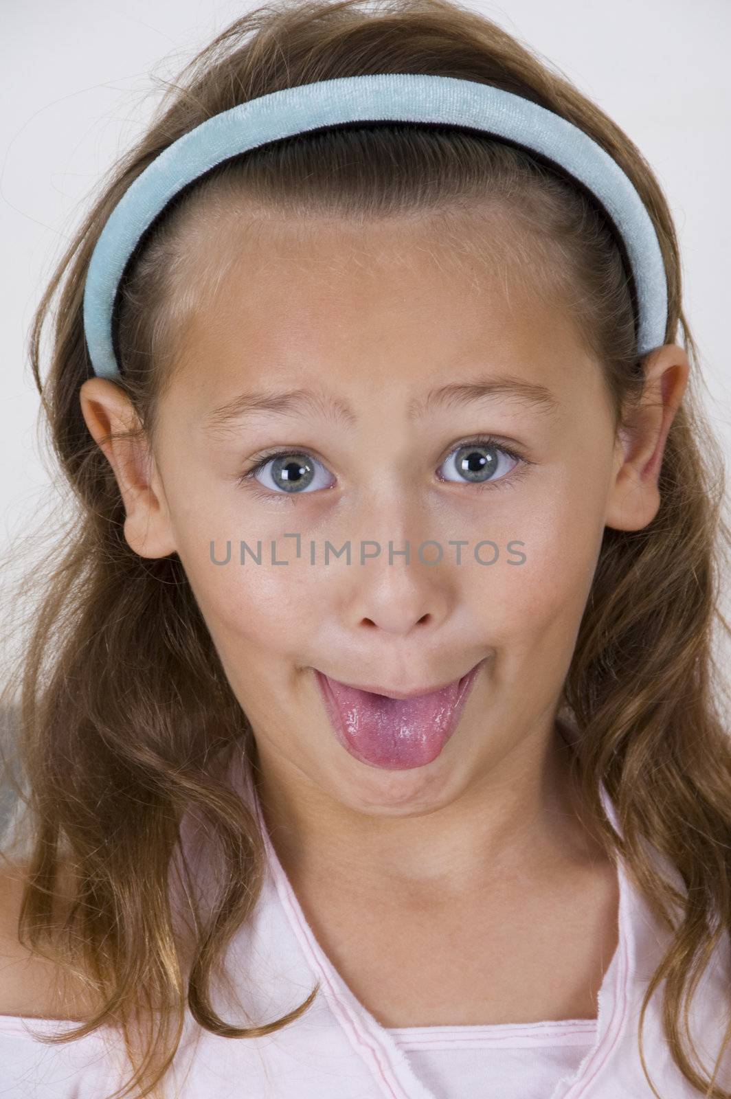 little girl showing her tongue