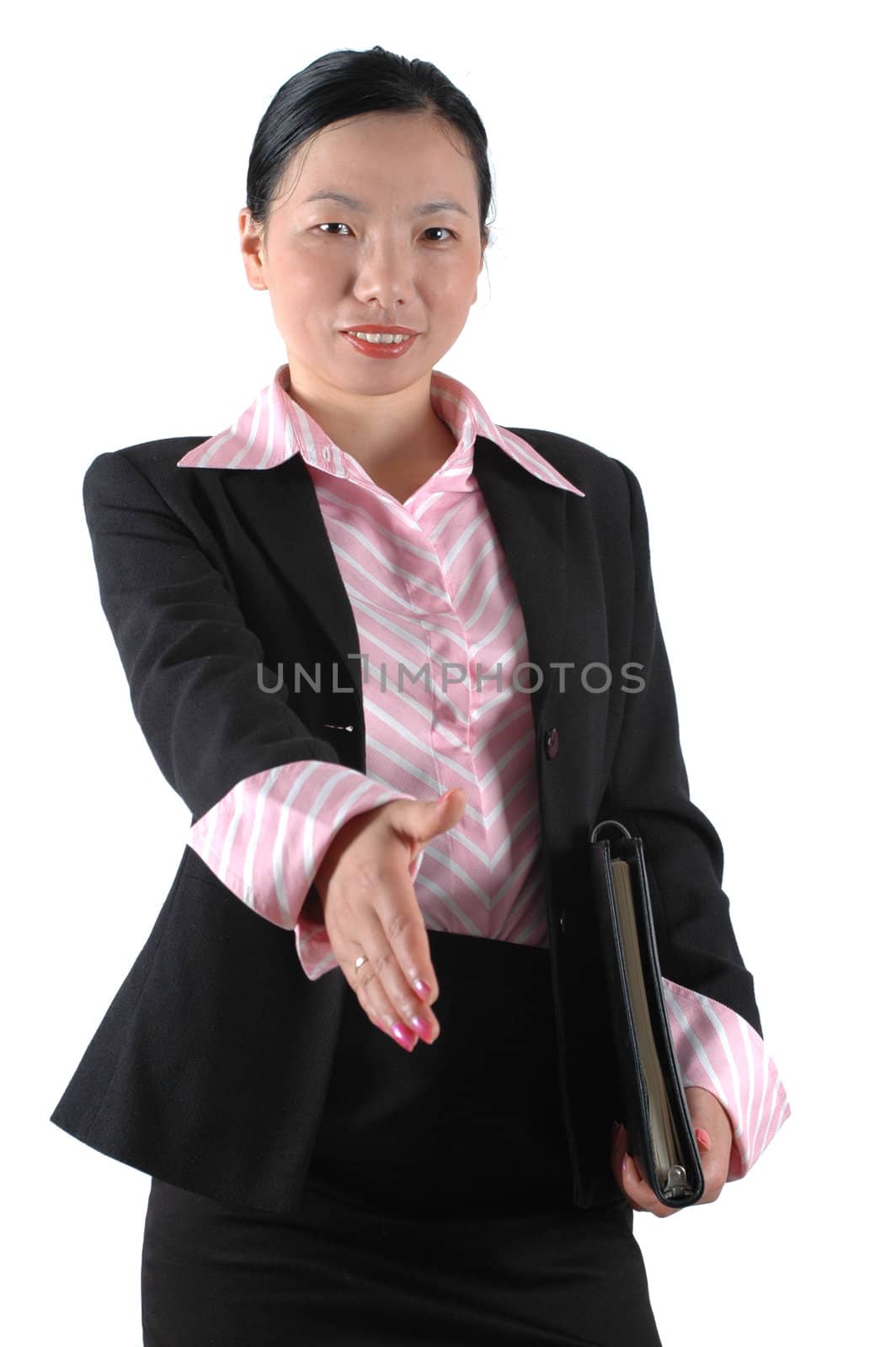 Yong businesswoman, wearing lady's suit and shirt. Welcoming business partners, shaking hands.