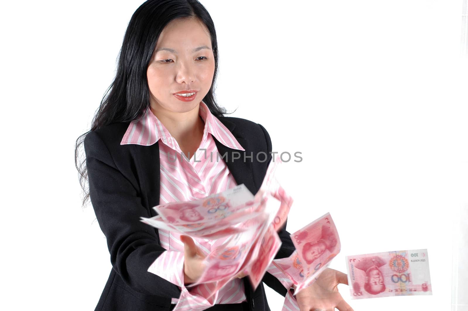 Young, Asian businesswoman throwing money, Chinese RMB banknotes, wearing lady's suit and shirt. 