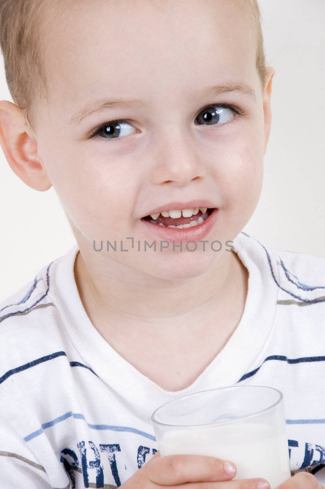 healthy boy drinking milk in glass