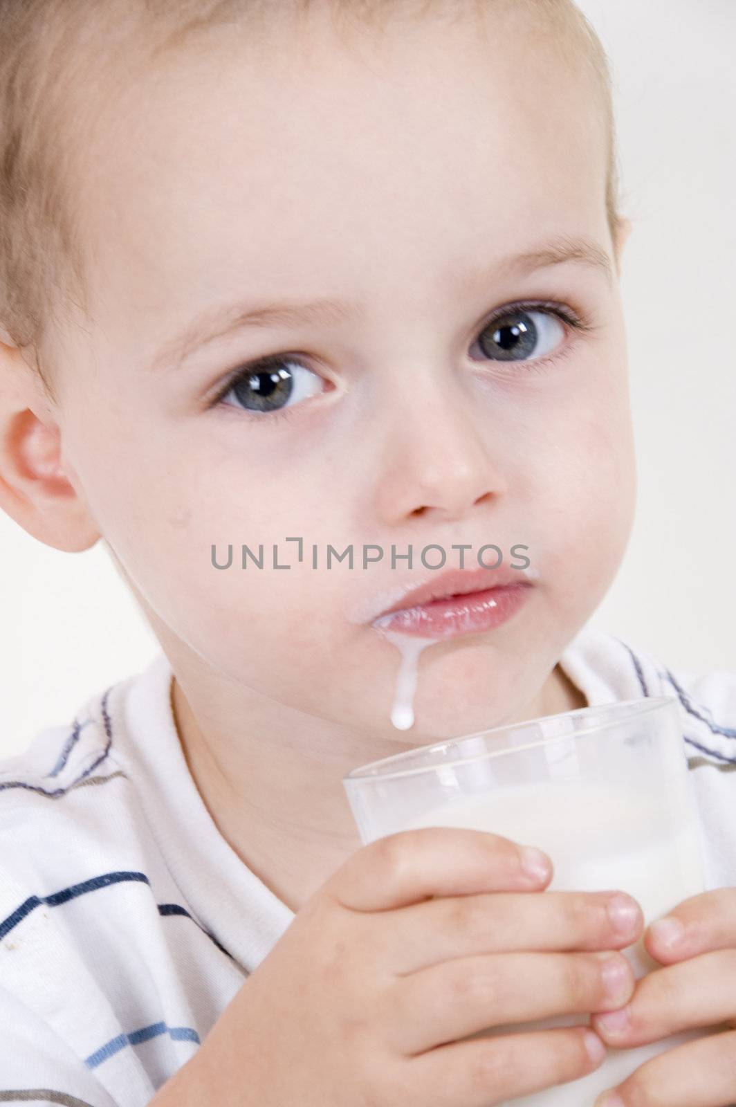 portrait of a little boy drinking milk