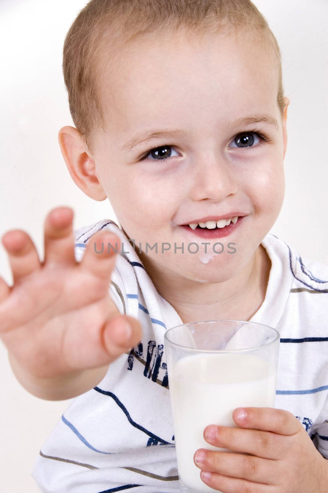 portrait of smiling boy with milk glass