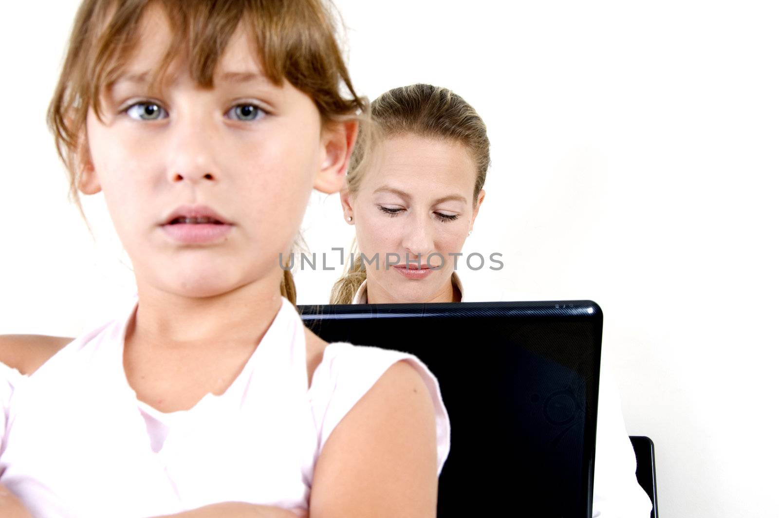 cute girl and her mother working on notebook