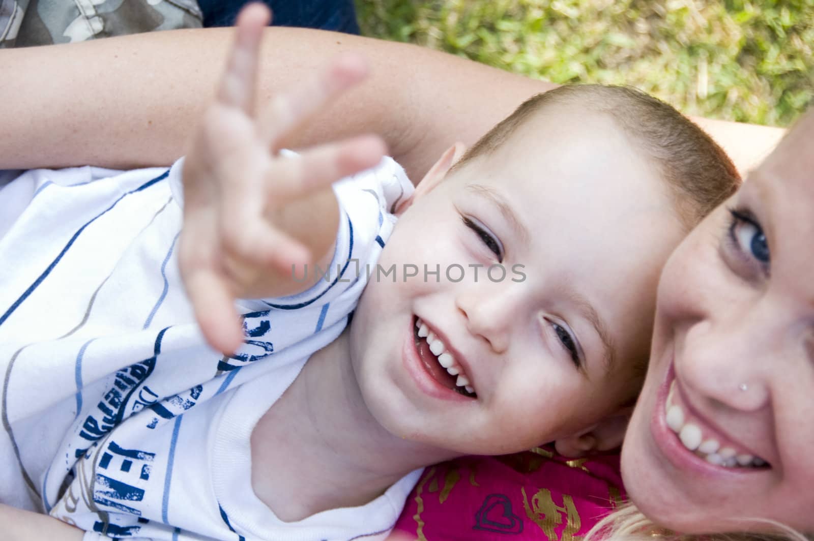 happy mother and child with open palm posing towards camera