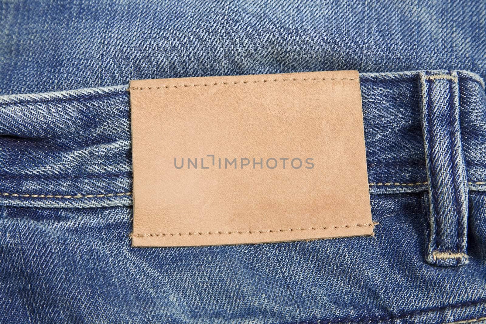 front view of denim label, blue jeans and leather label