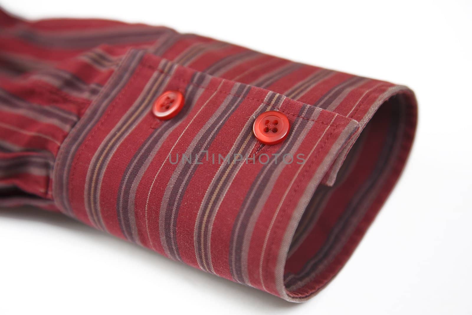 close up of the red cuff from striped shirt