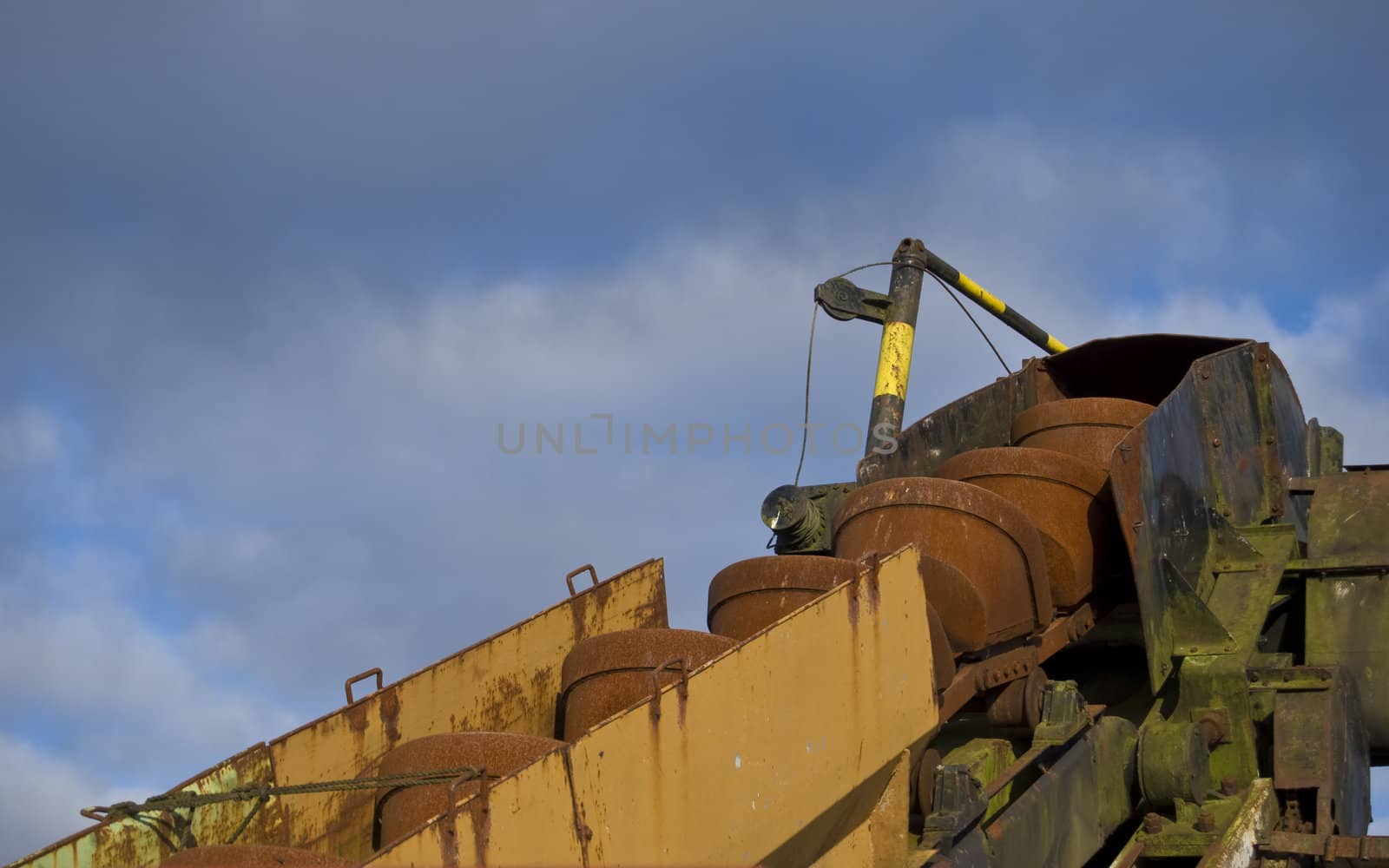 part of a conveyor against a cloudy sky