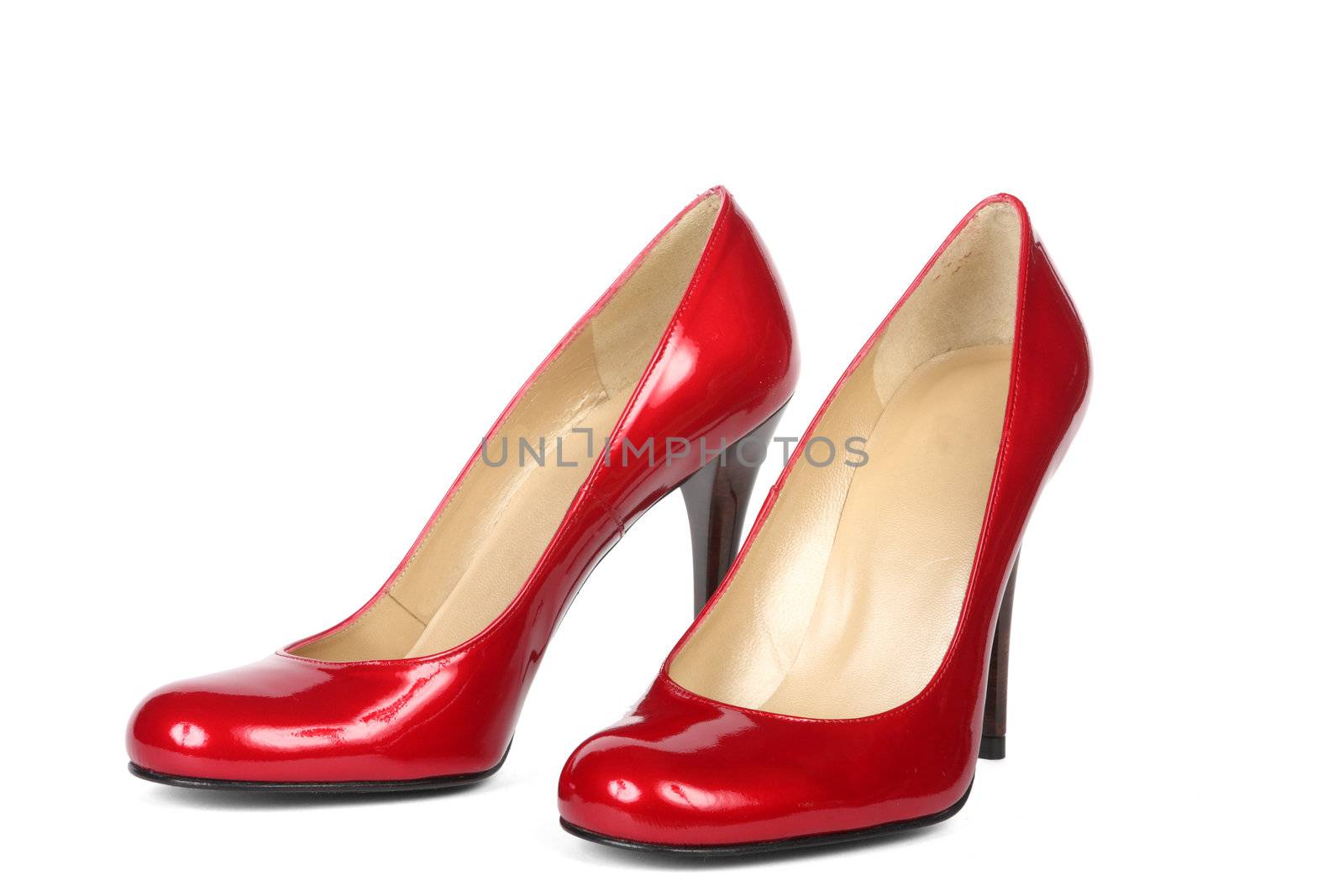 Red female shoes on a high heel. It is isolated on a white background