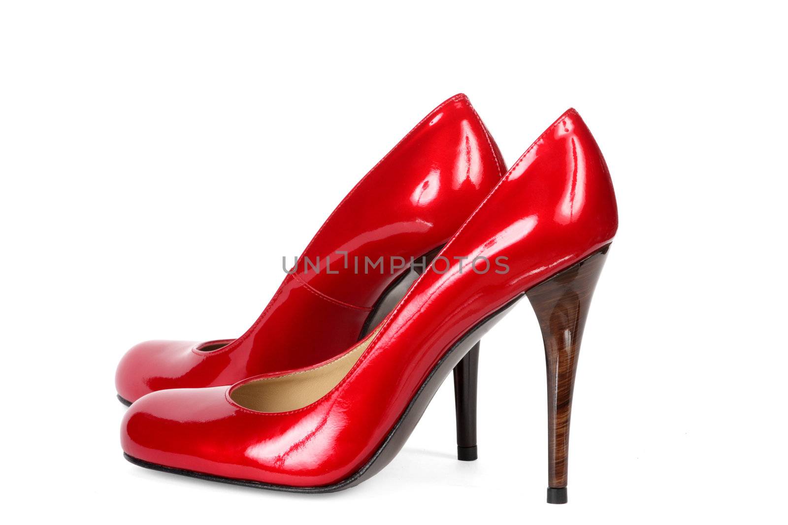 Red female shoes on a high heel. It is isolated on a white background