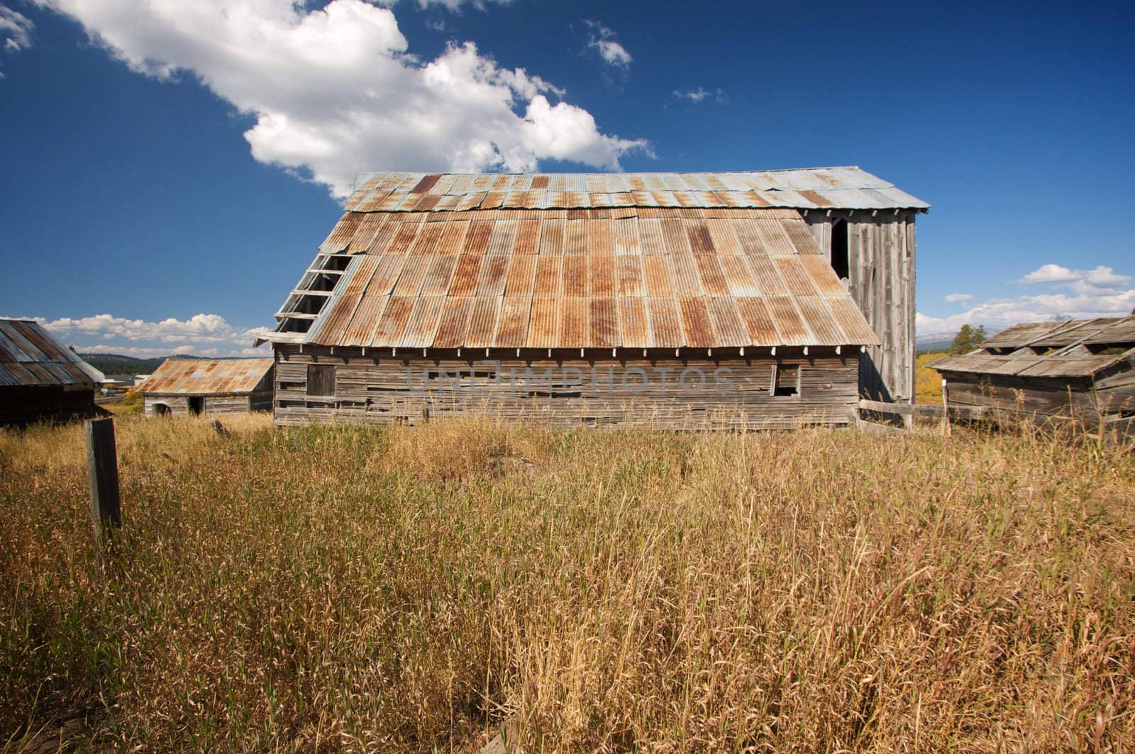 Rustic Barn Scene with Deep Blue Sky and Clouds