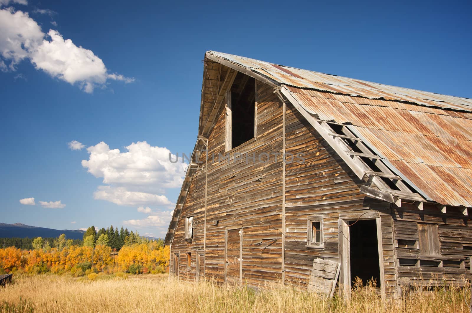 Rustic Barn Scene with Deep Blue Sky and Clouds