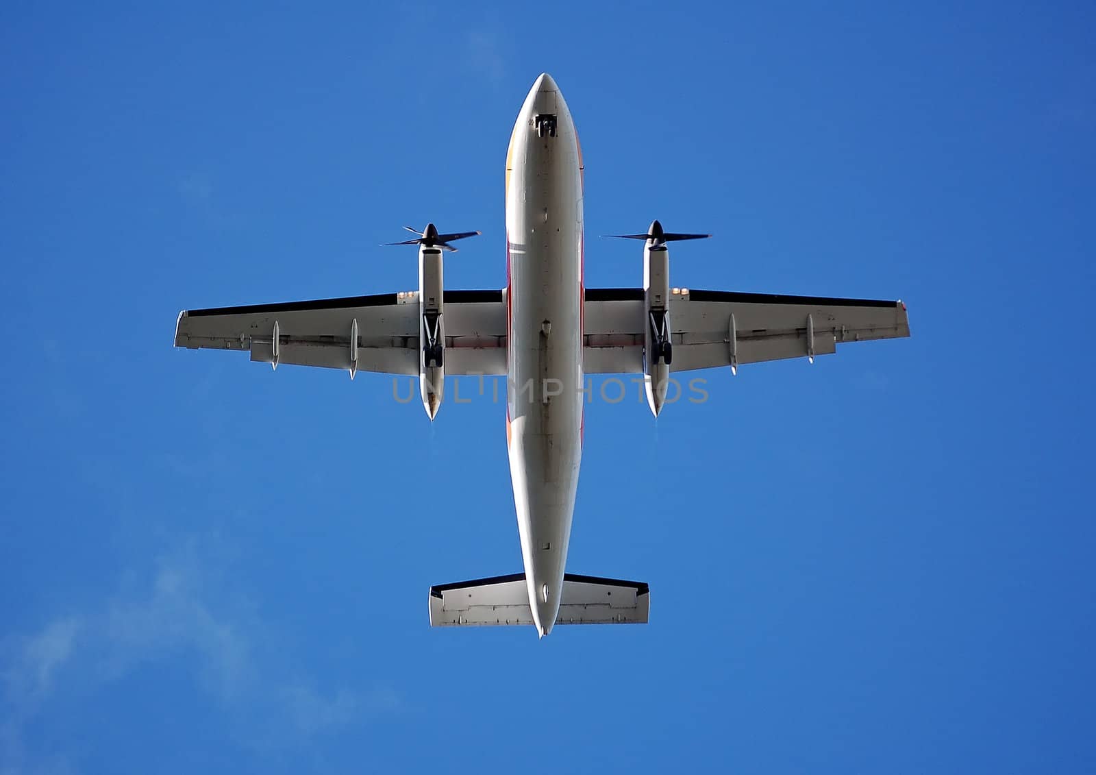 Aircraft flying directly above with a blue sky as a background