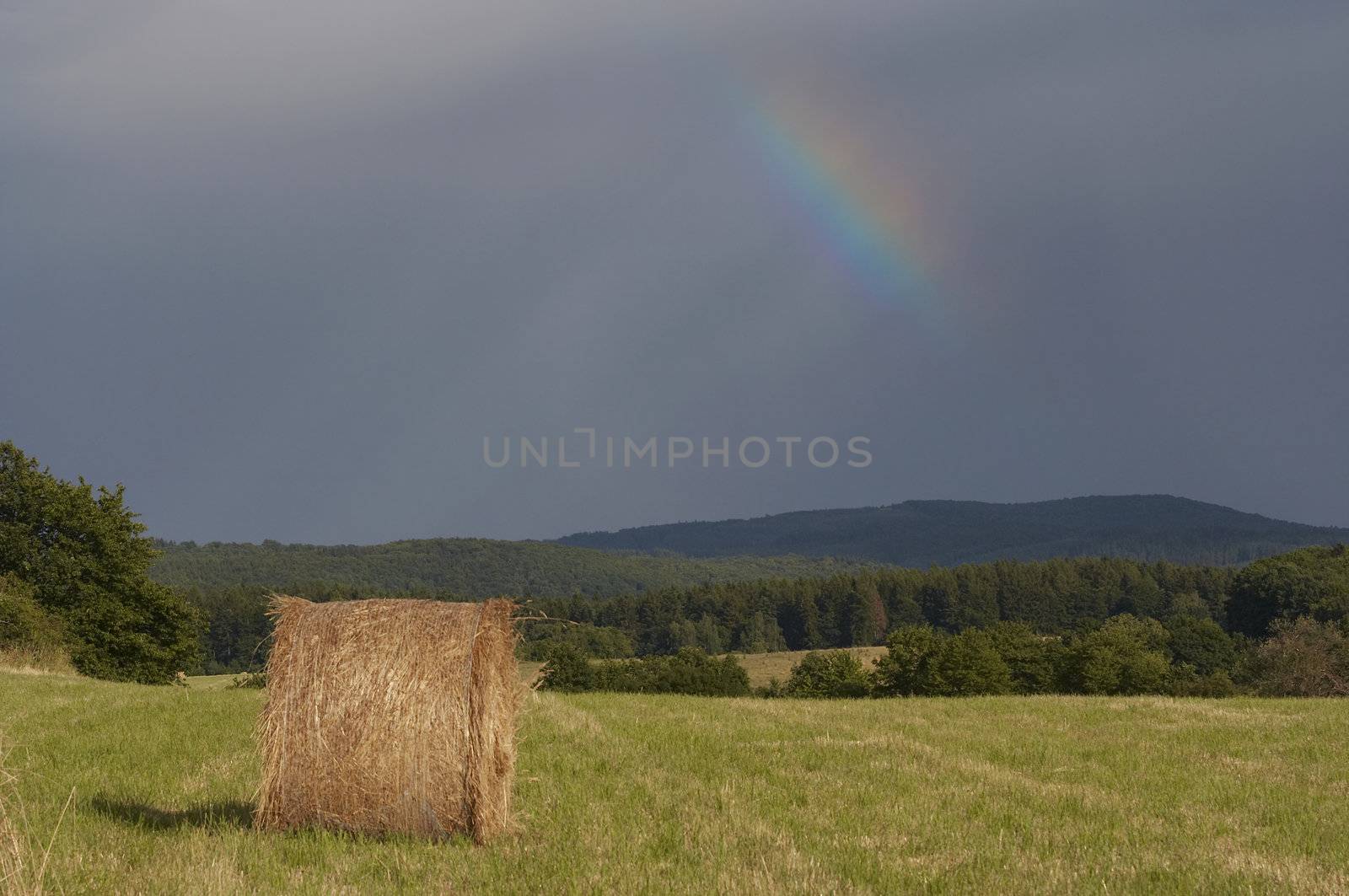 Shot of the dark sky with rainbow