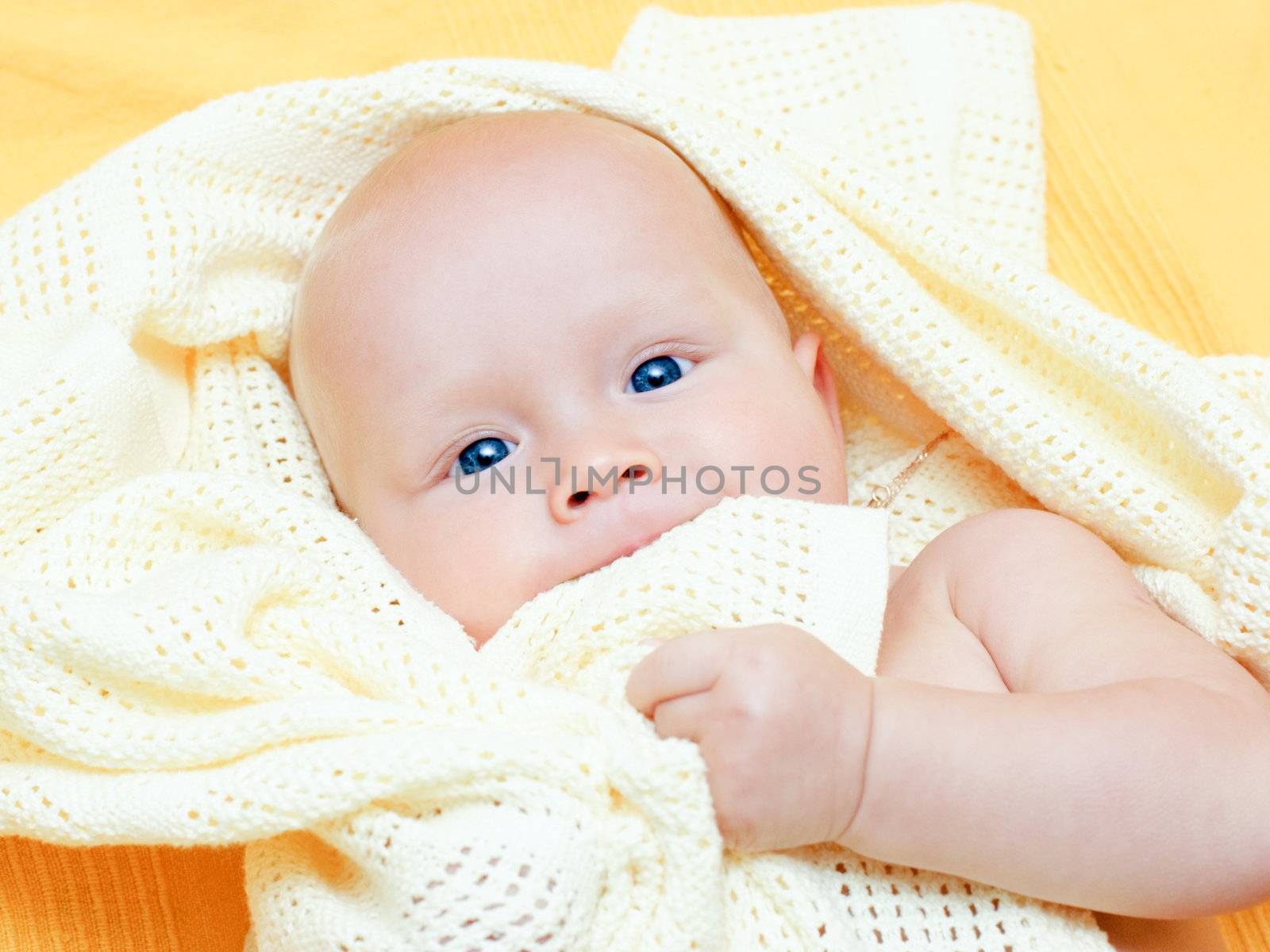 Seven month baby girl playing with blanket