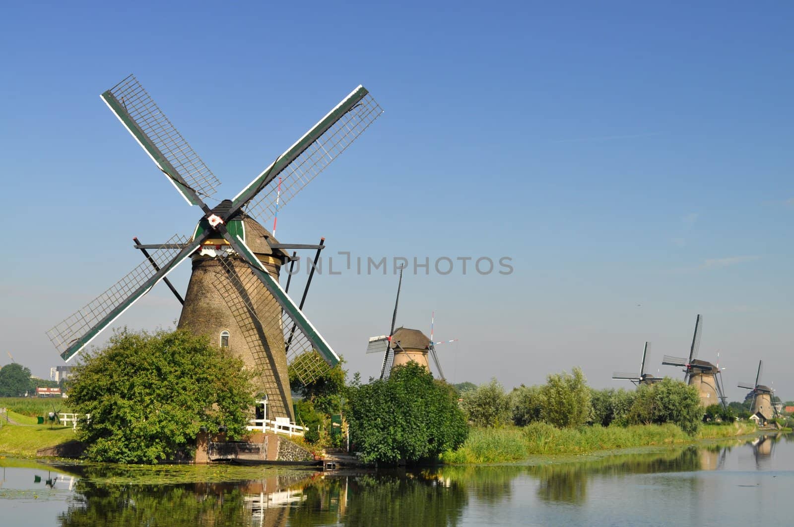 Dutch mills over a river by rigamondis