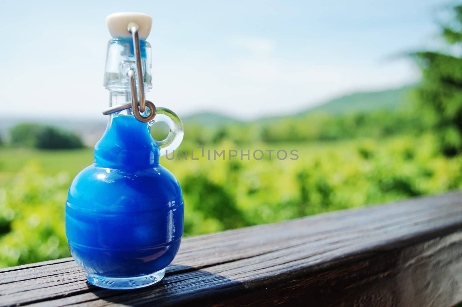 Small blue bottle full of liquid, Sky needs more blue