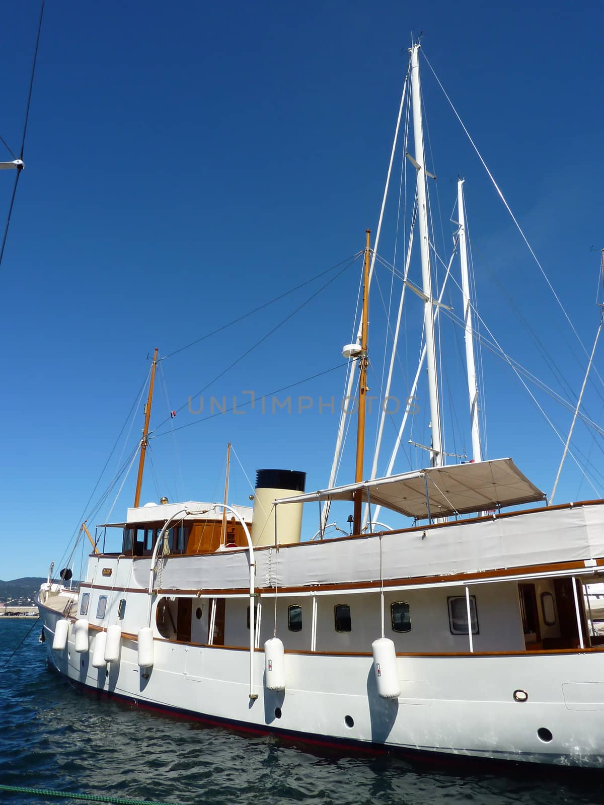 Big white boat with masts floating on the mediterranean sea by beautiful weather