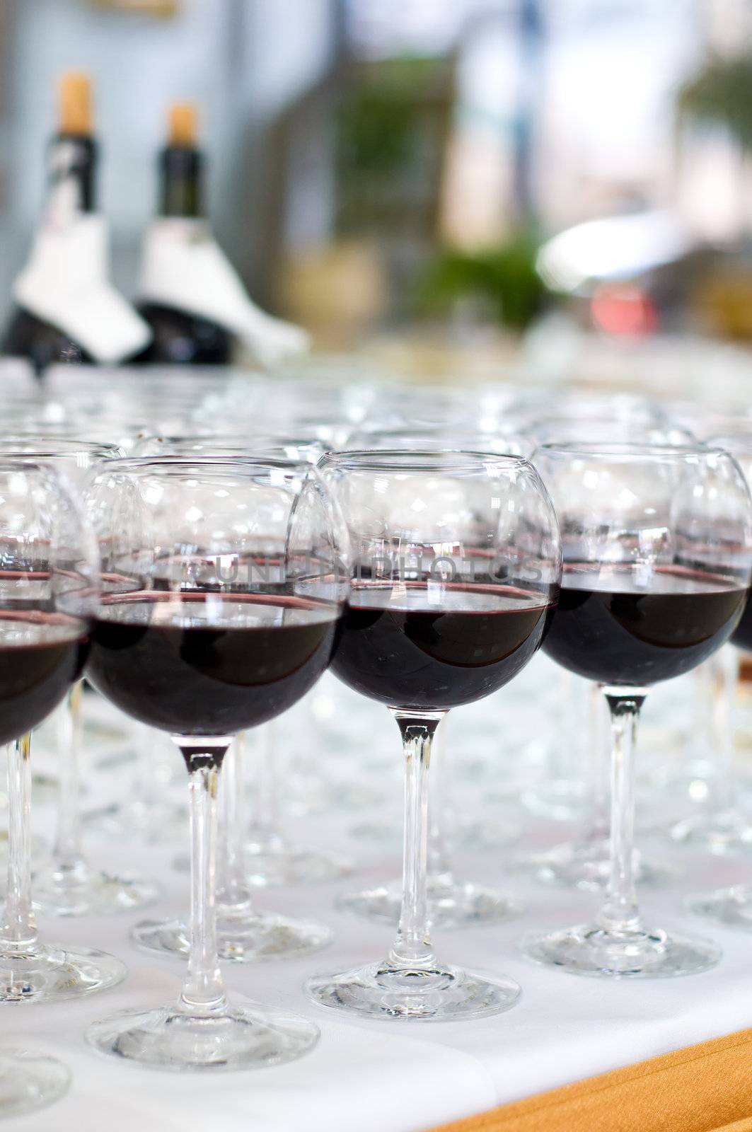 group arrangement of glasses with red wine, selective focus