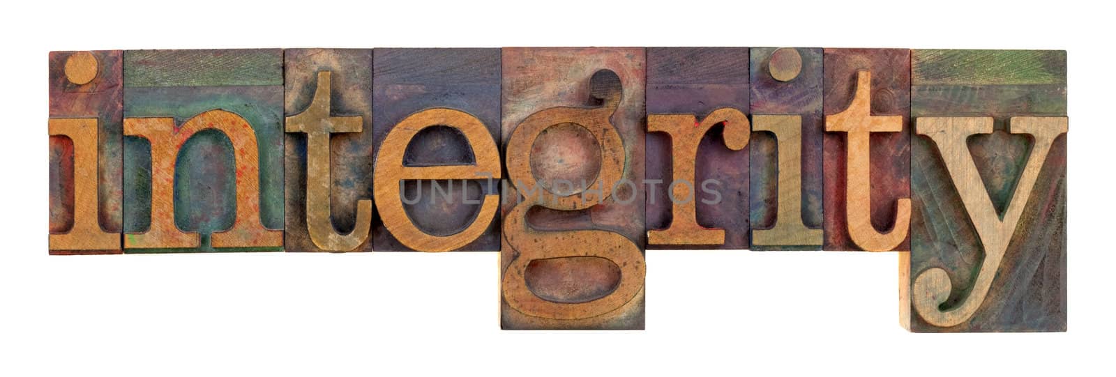 the word of integrity in vintage wood letterpress type, stained by color inks, isolated on white