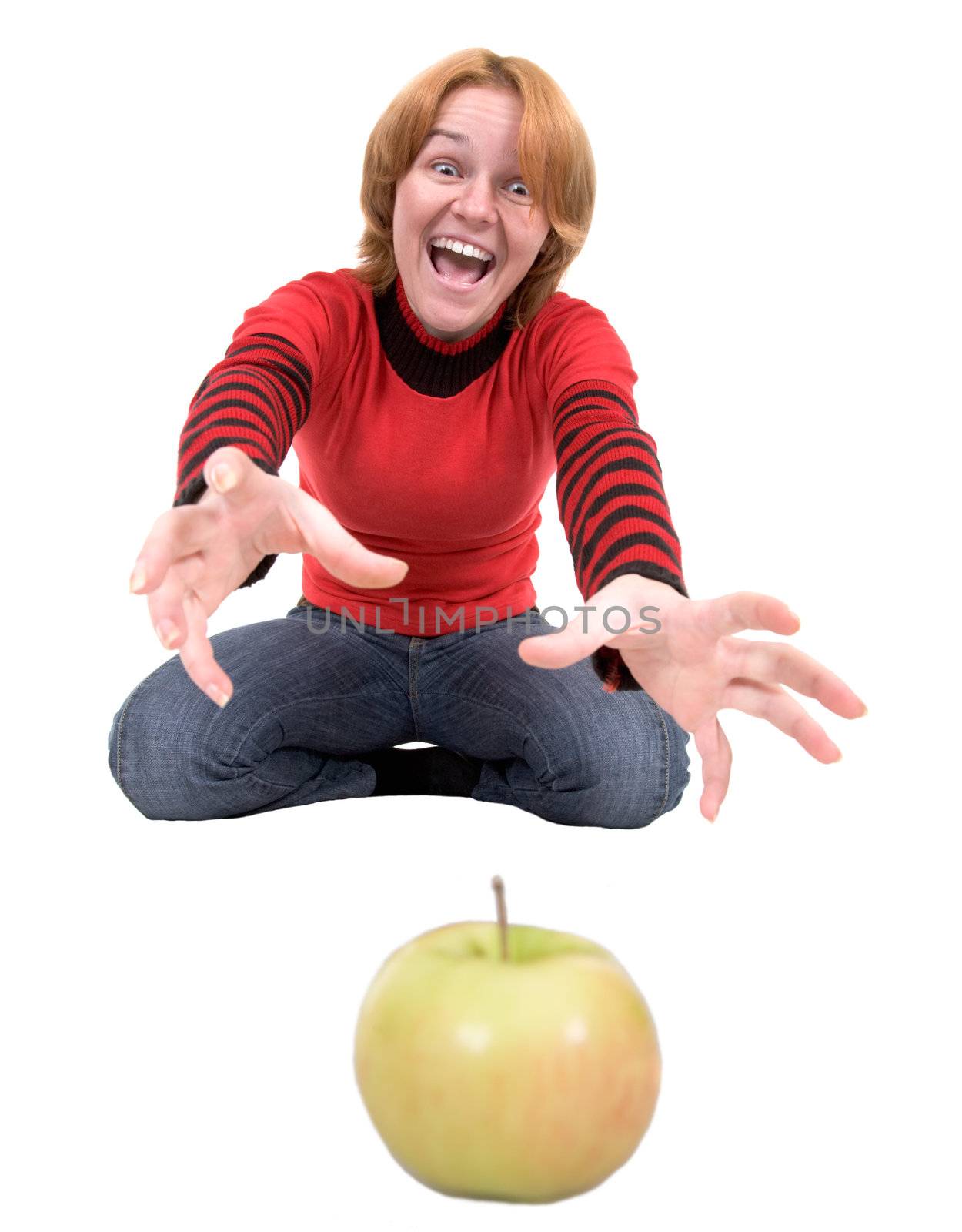 The woman stretch a hand to a green apple