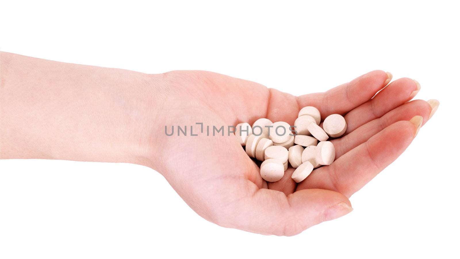 Handful of tablets on a female hand