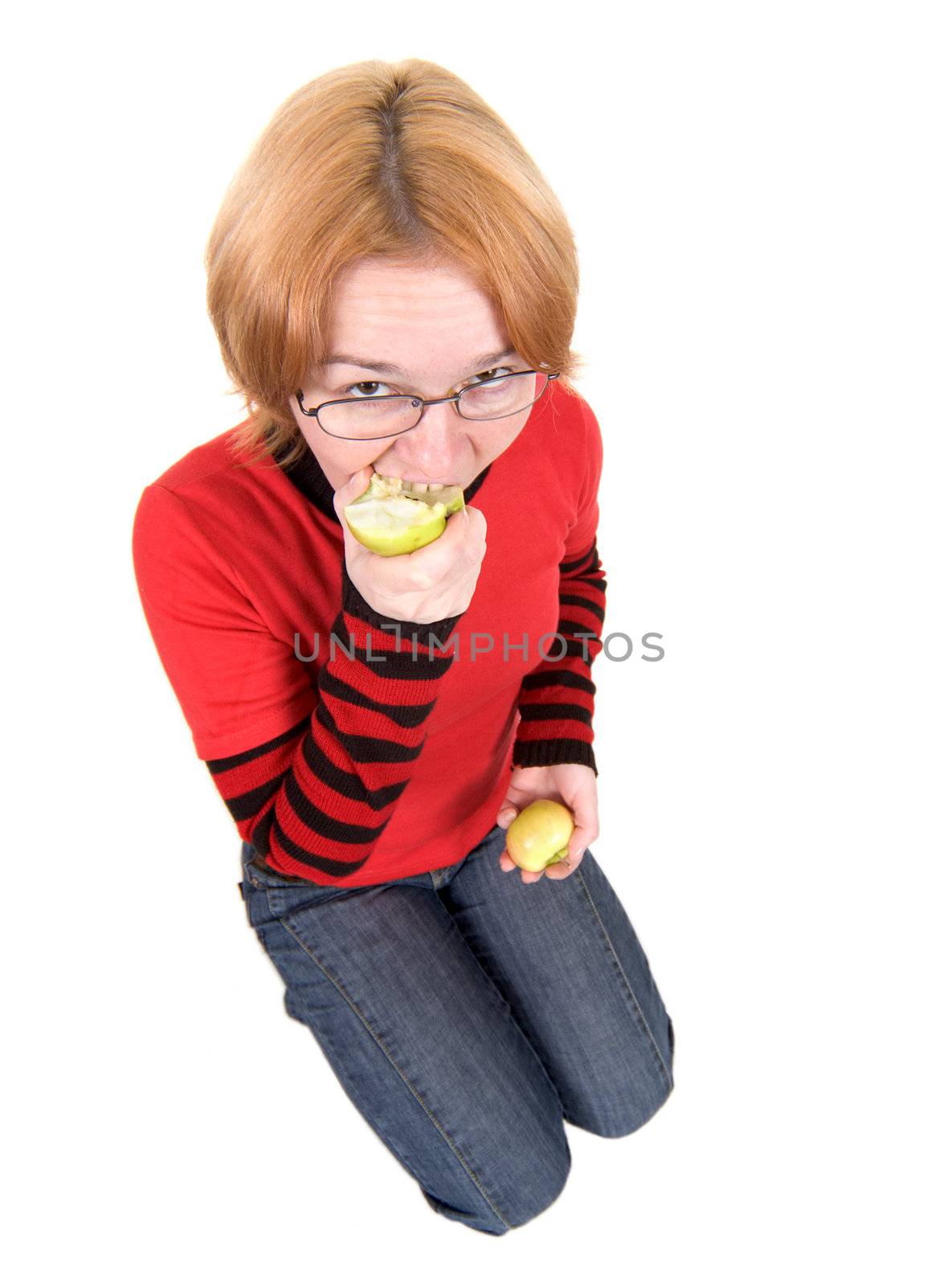 The girl in a red sweater eats an two apples