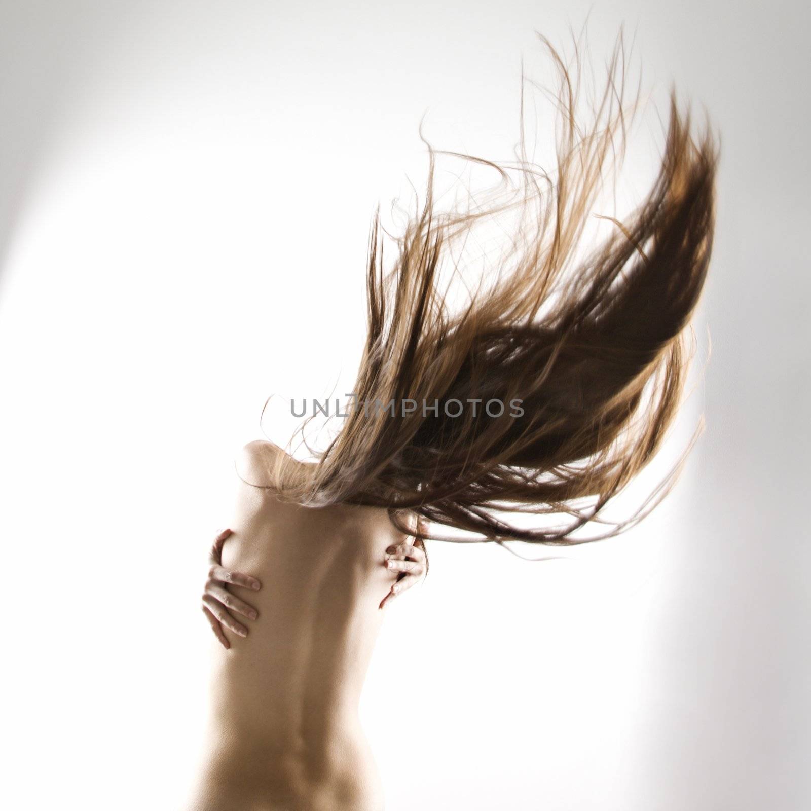 Topless Caucasian woman swinging her hair.