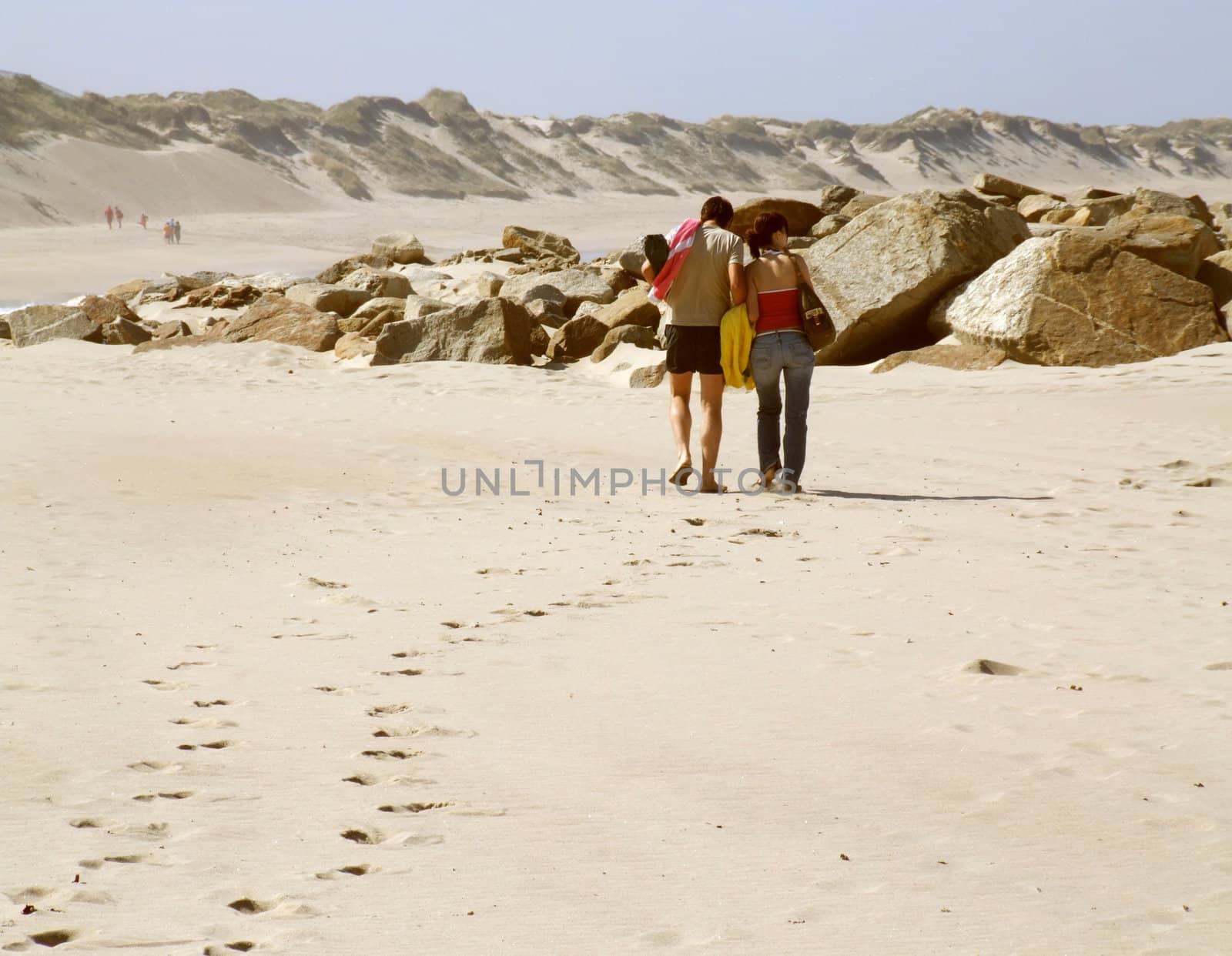 Couple walking along an empty beach