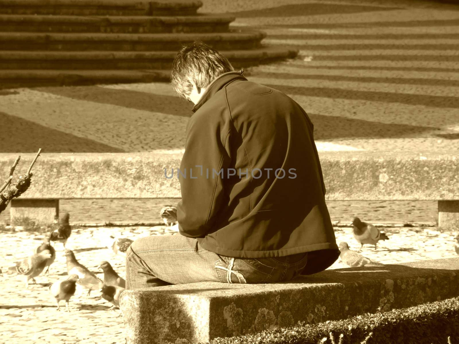 Man sited ona park bench reflecting