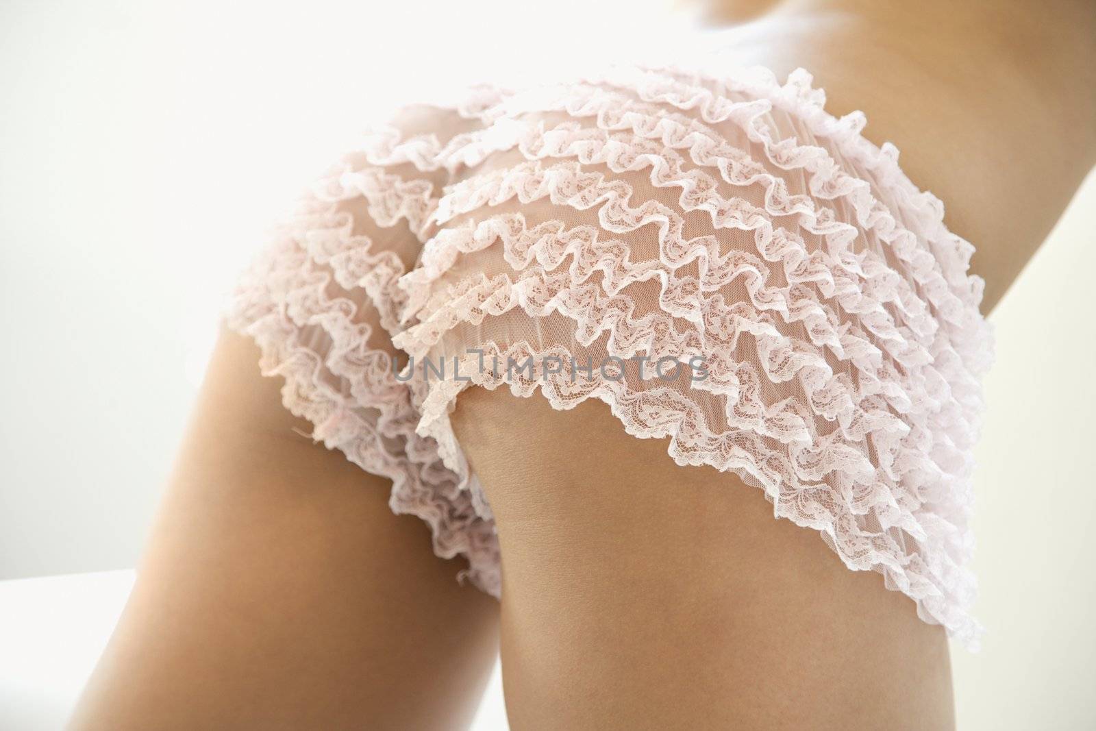 Lacey pink underwear on young adult woman.