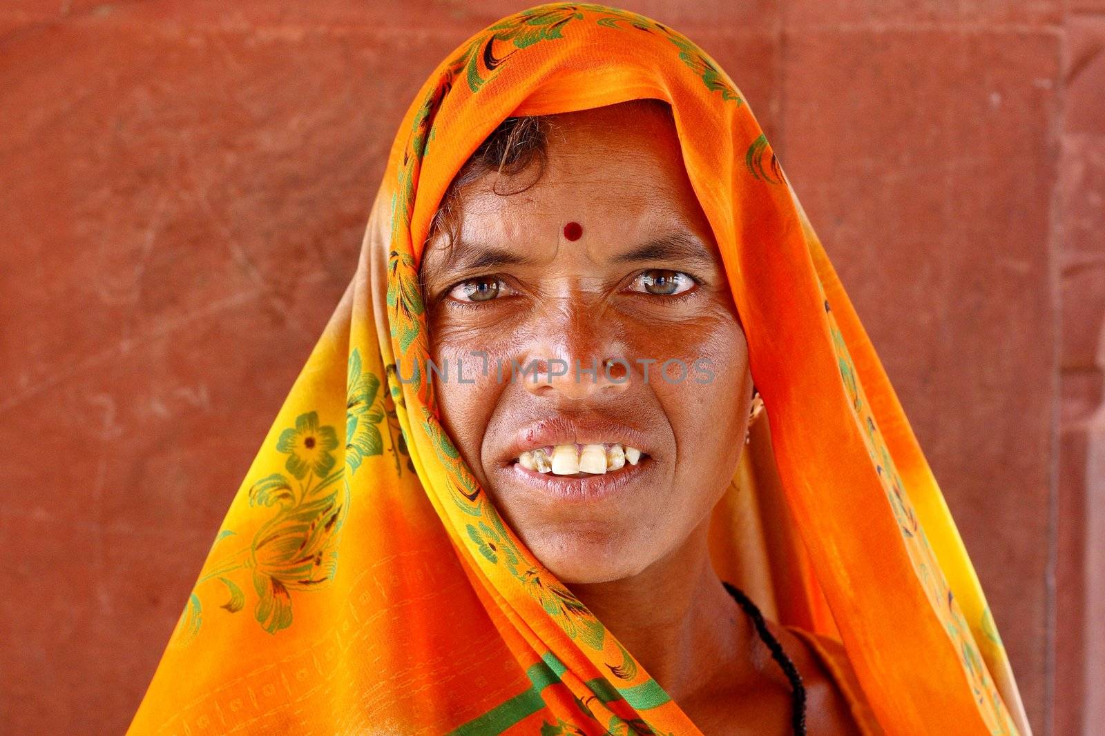 Old woman wearing a beautifully embroidered sari