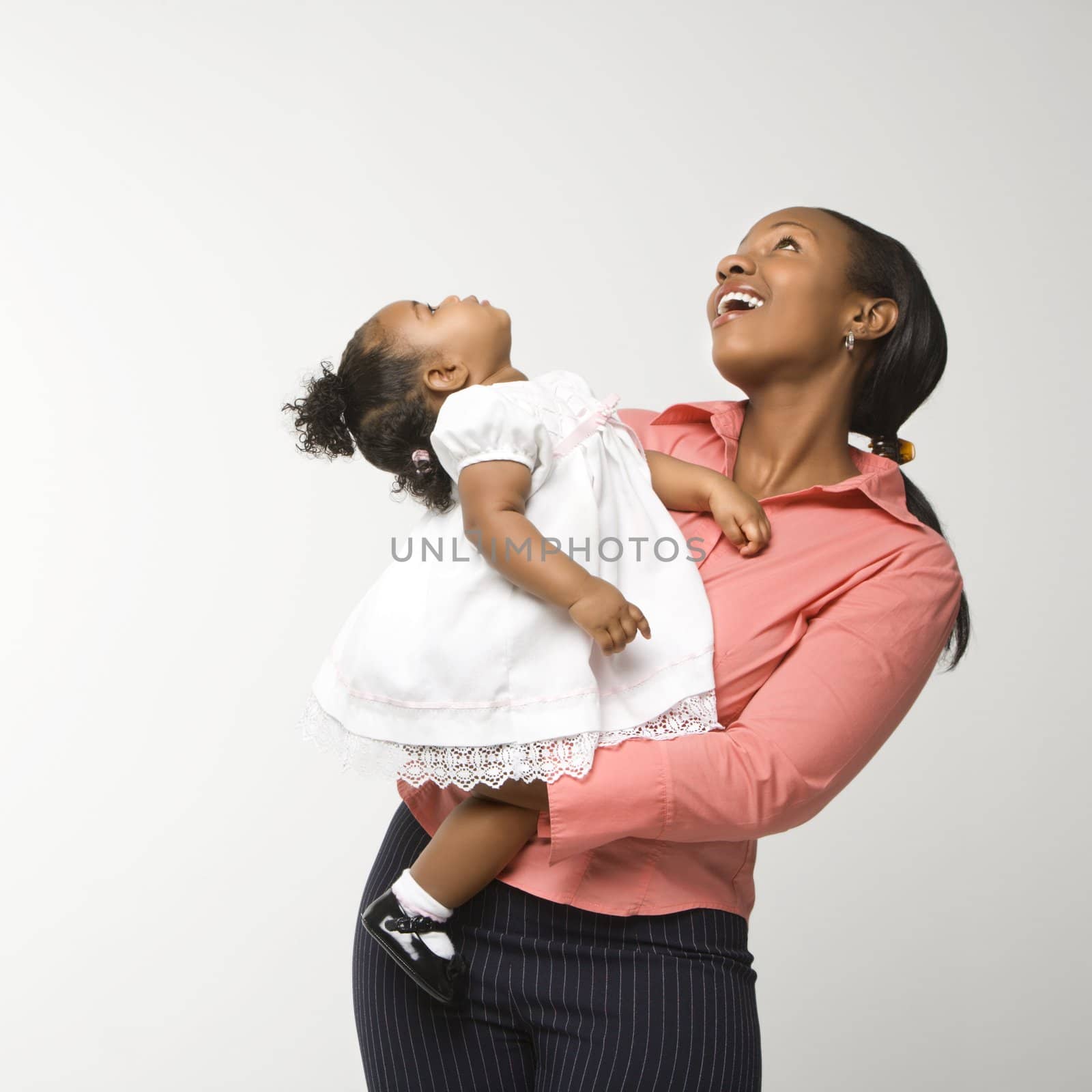 Woman holding infant girl. by iofoto