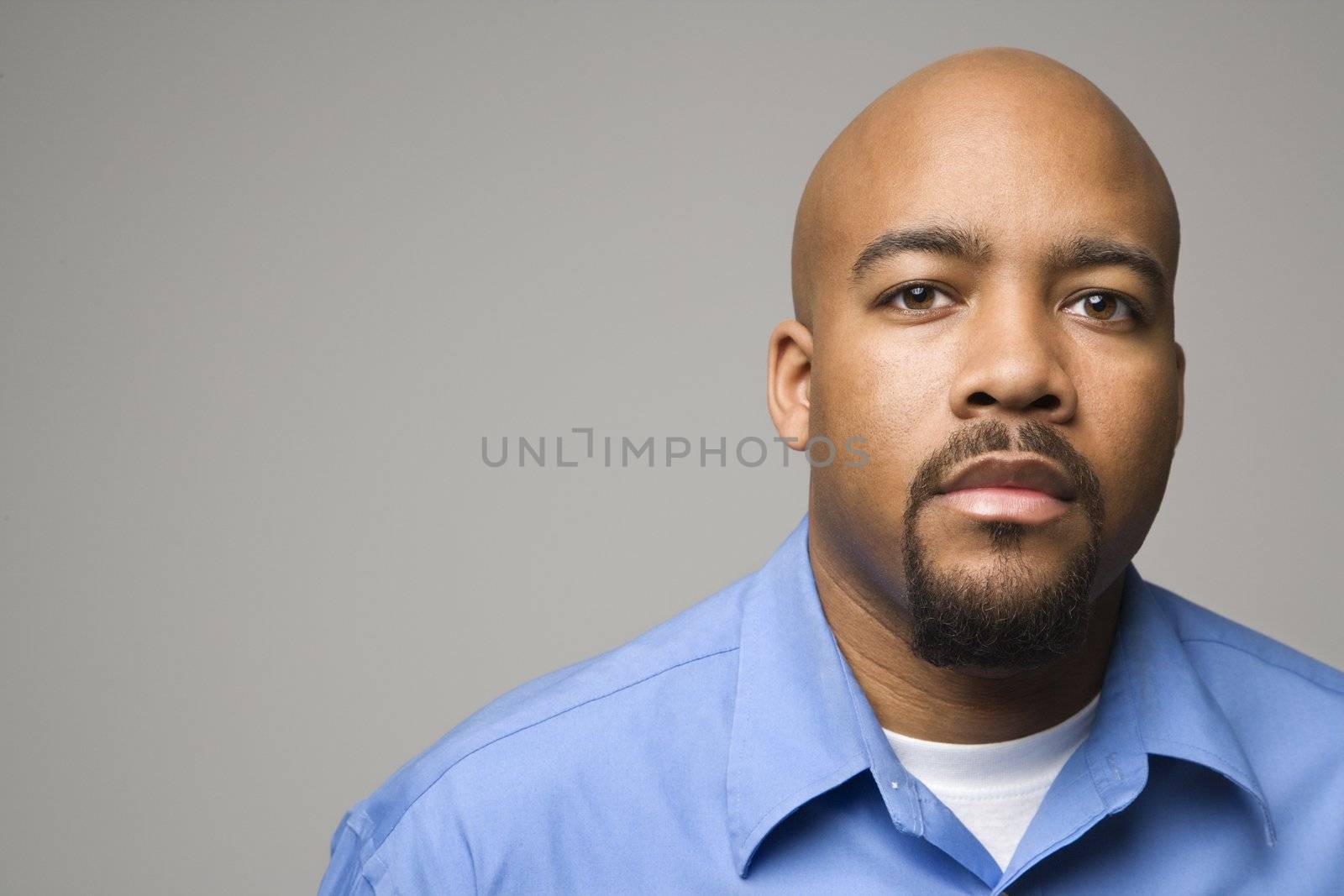 Portrait of African American man against gray background.