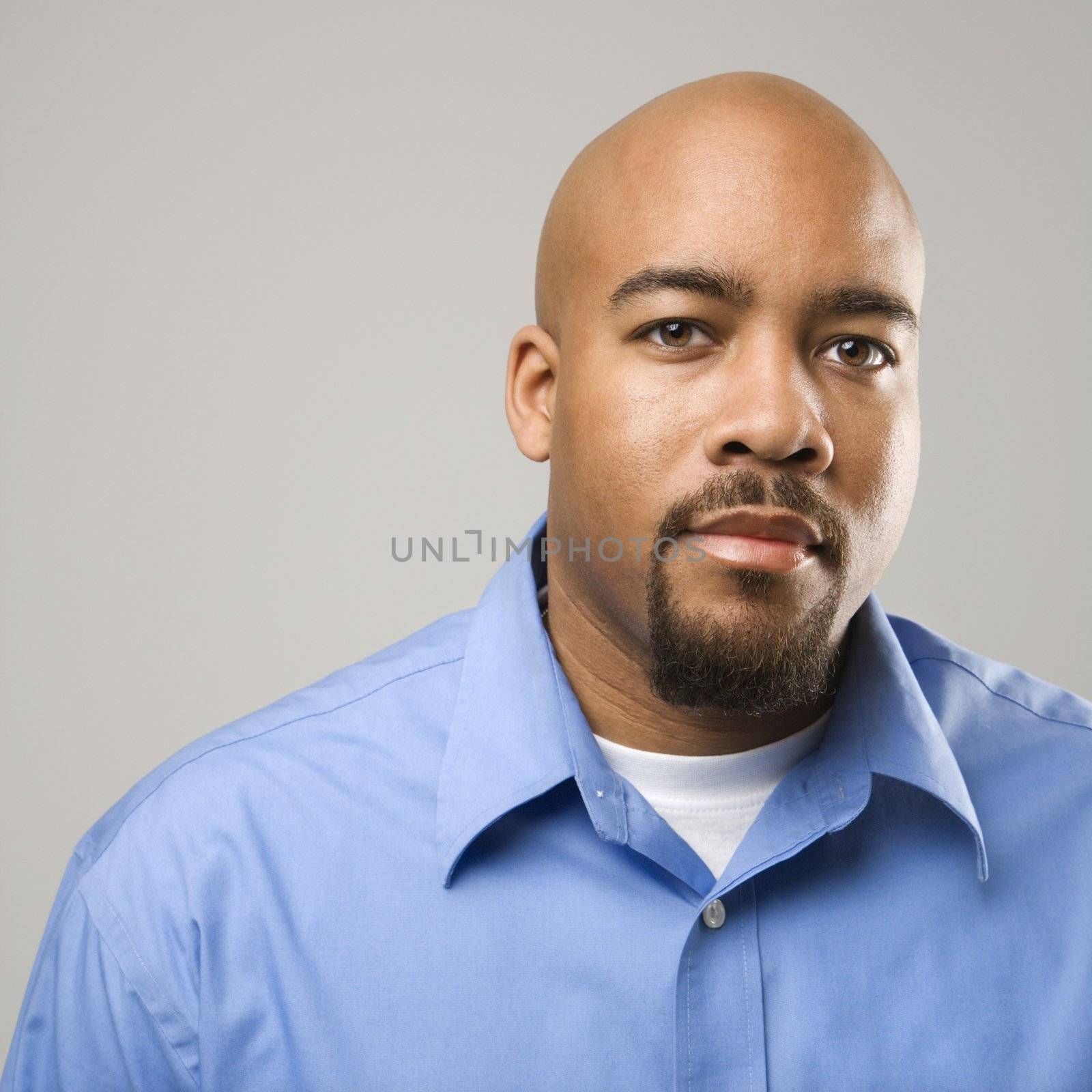 Portrait of African American man against gray background.