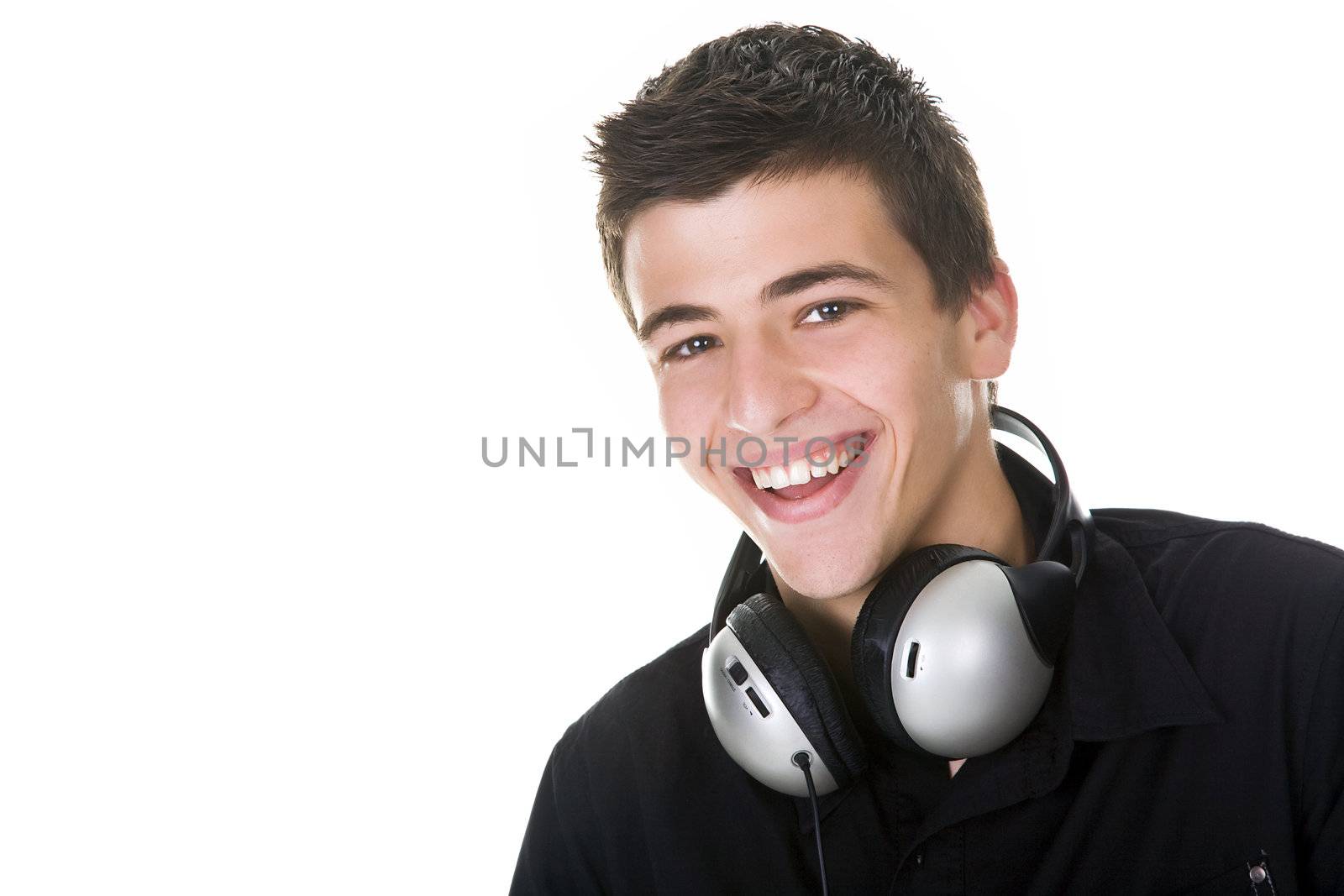 Portrait of a happy young man smiling, with headphones.