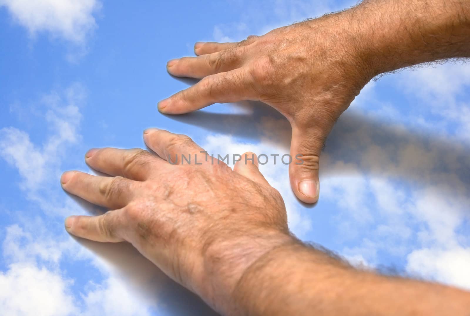 The male hands on summer sky. Collage.