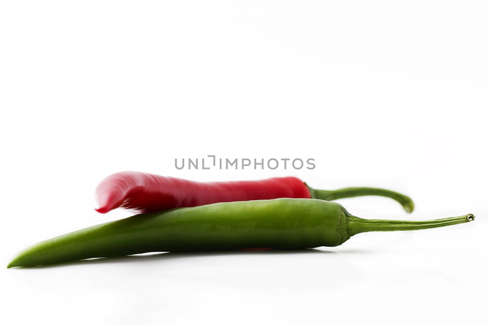 one red and a green chili isolated on white background