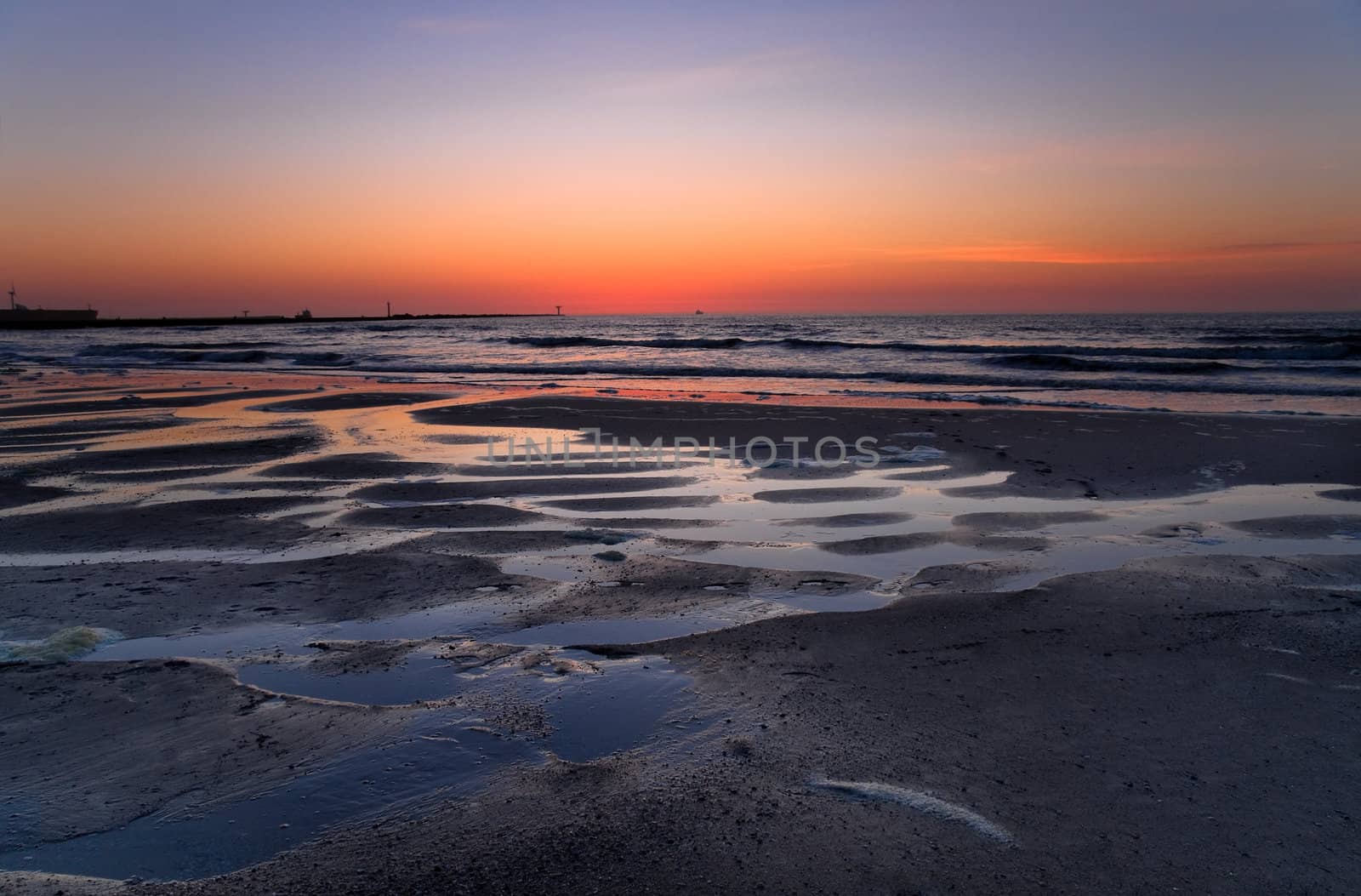 Coloured sky from volcanodust in the air after the sunset at the beach -  horizontal image