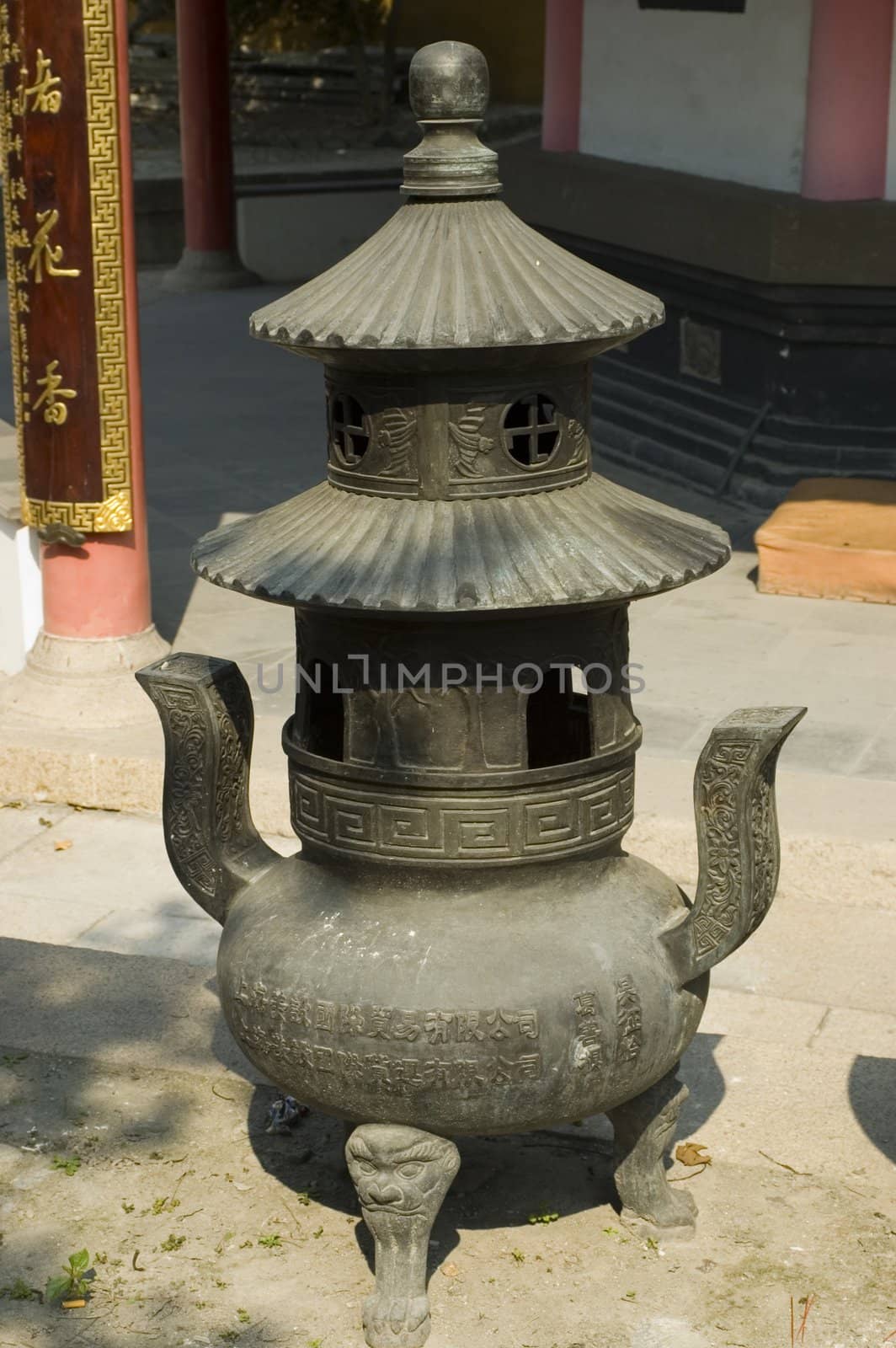 Traditional Chinese temple in Nantong city, Jiangsu province, China. Temple consists of few buildings, tower, monk's hostel and fireplace for incense. 