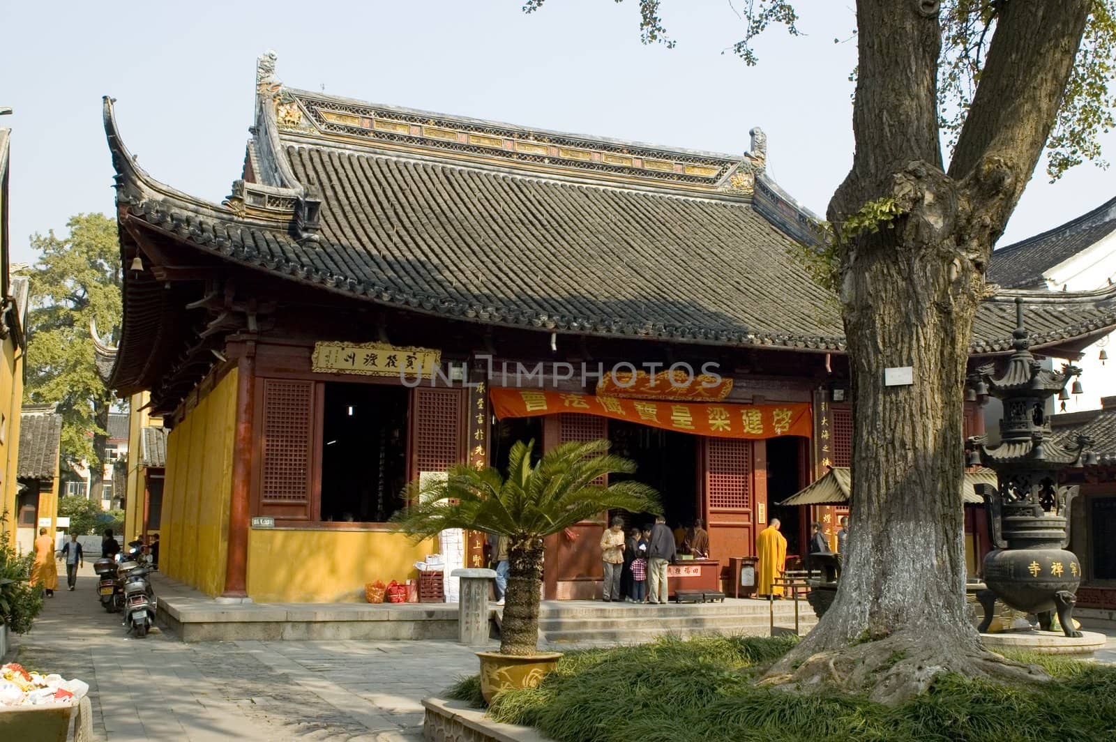 Traditional Chinese temple in Nantong city, Jiangsu province, China. Temple consists of few buildings, tower, monk's hostel and fireplace for incense. 