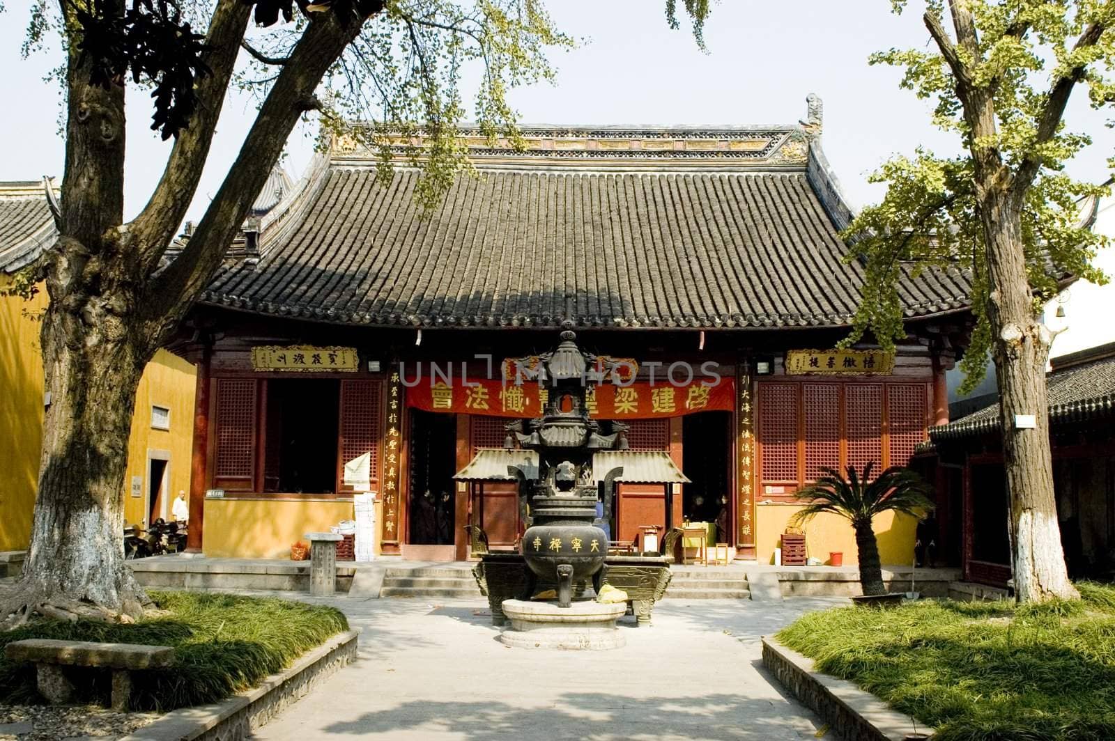 Traditional Chinese temple in Nantong city, Jiangsu province, China. Temple consists of few buildings, tower, monk's hostel and fireplace for incense. 