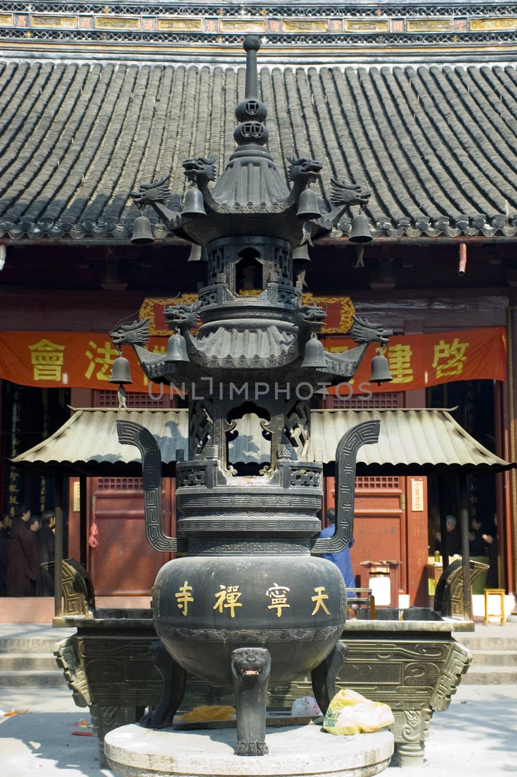 Traditional Chinese temple in Nantong city, Jiangsu province, China. Temple consists of few buildings, tower, monk's hostel and fireplace for incense. 