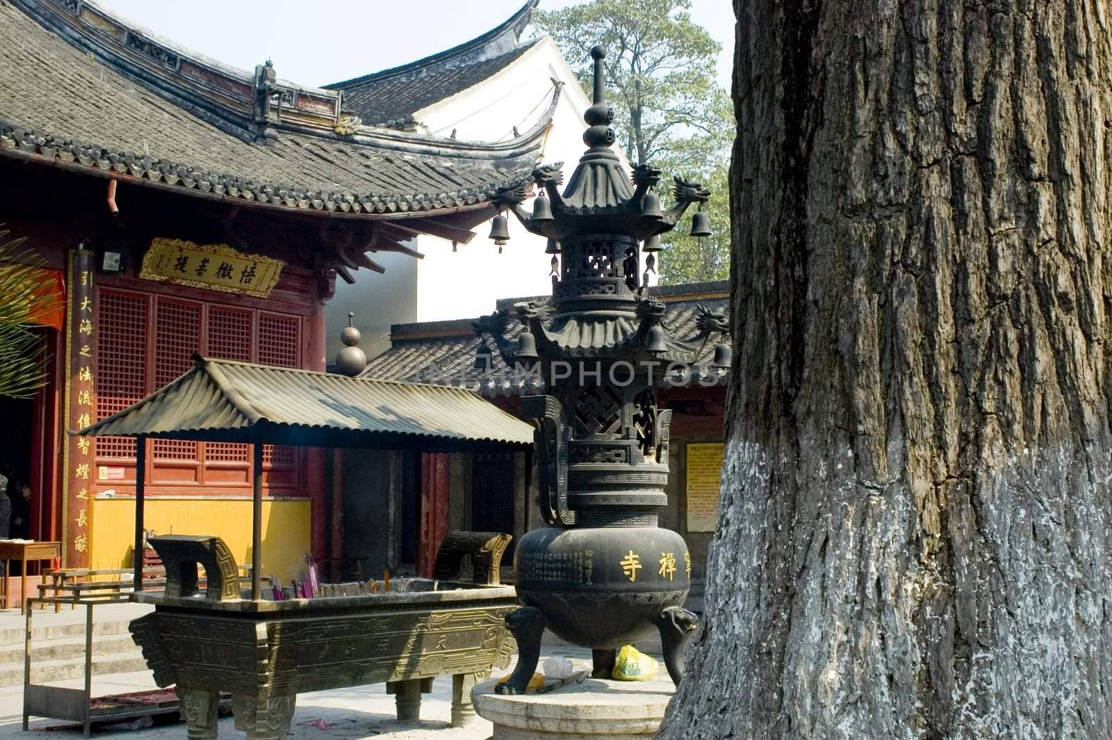 Traditional Chinese temple in Nantong city, Jiangsu province, China. Temple consists of few buildings, tower, monk's hostel and fireplace for incense. 