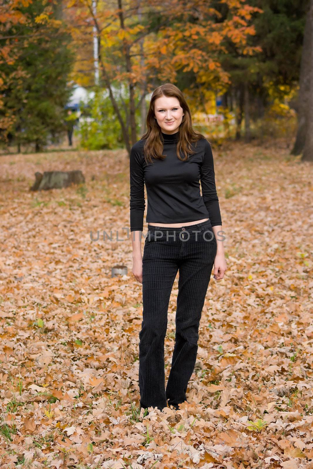 The young girl against autumn nature