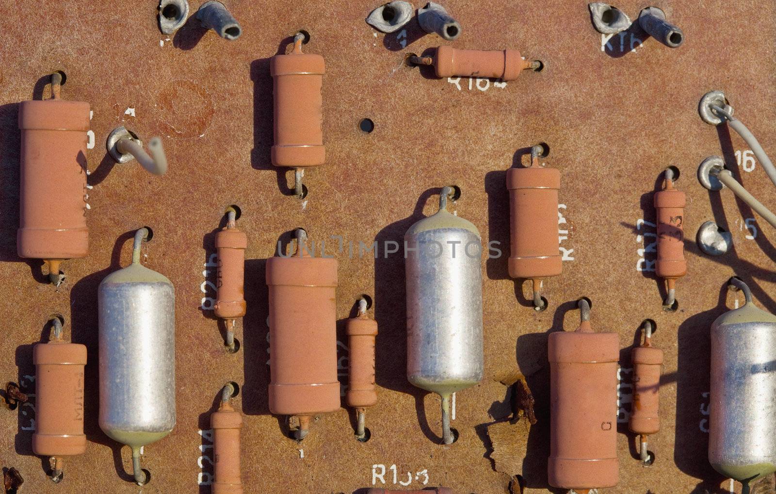 Old spoiled electronic plate with resistors and capacitors